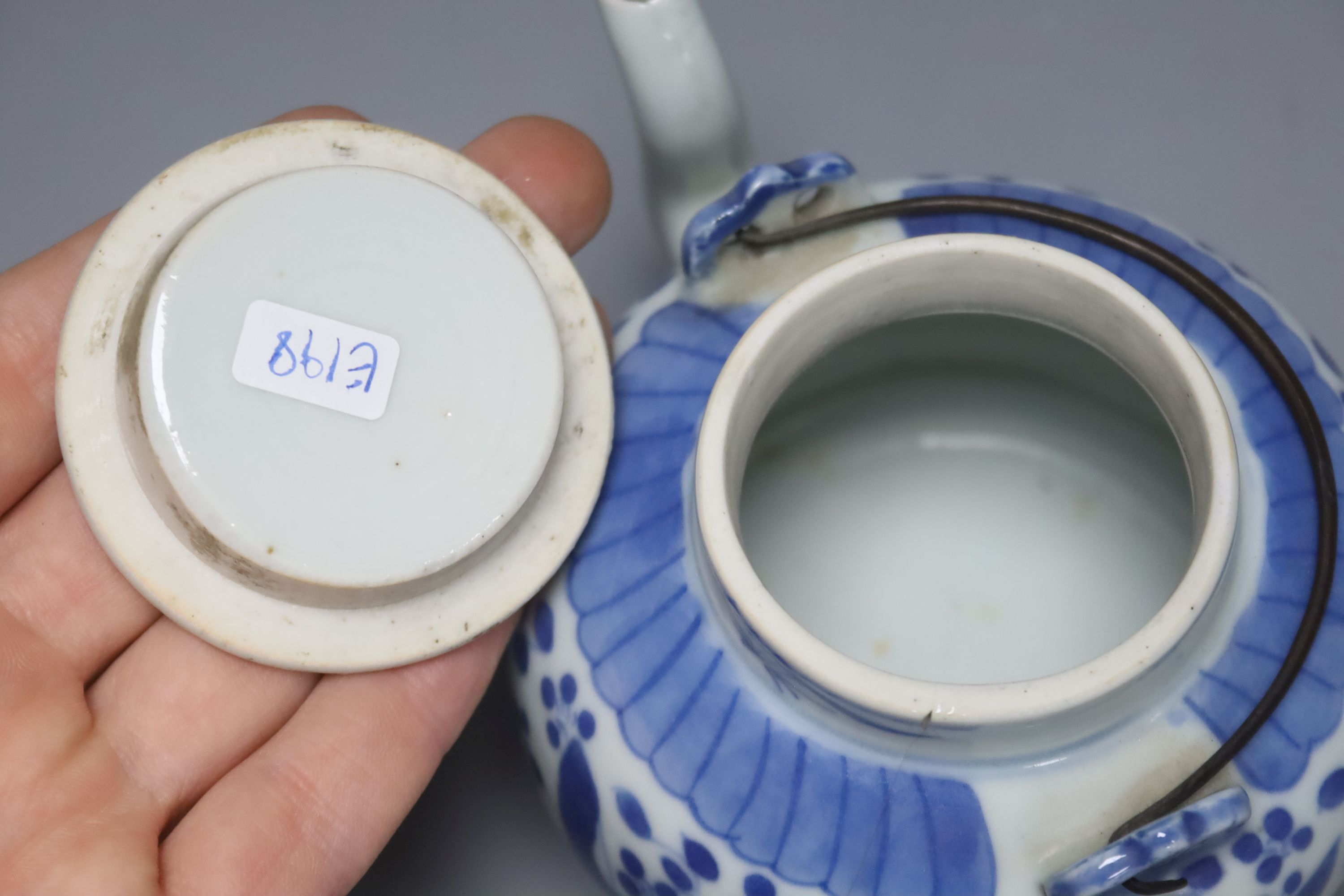 Two 19th century Chinese blue and white moon flasks and a teapot, tallest 21cm